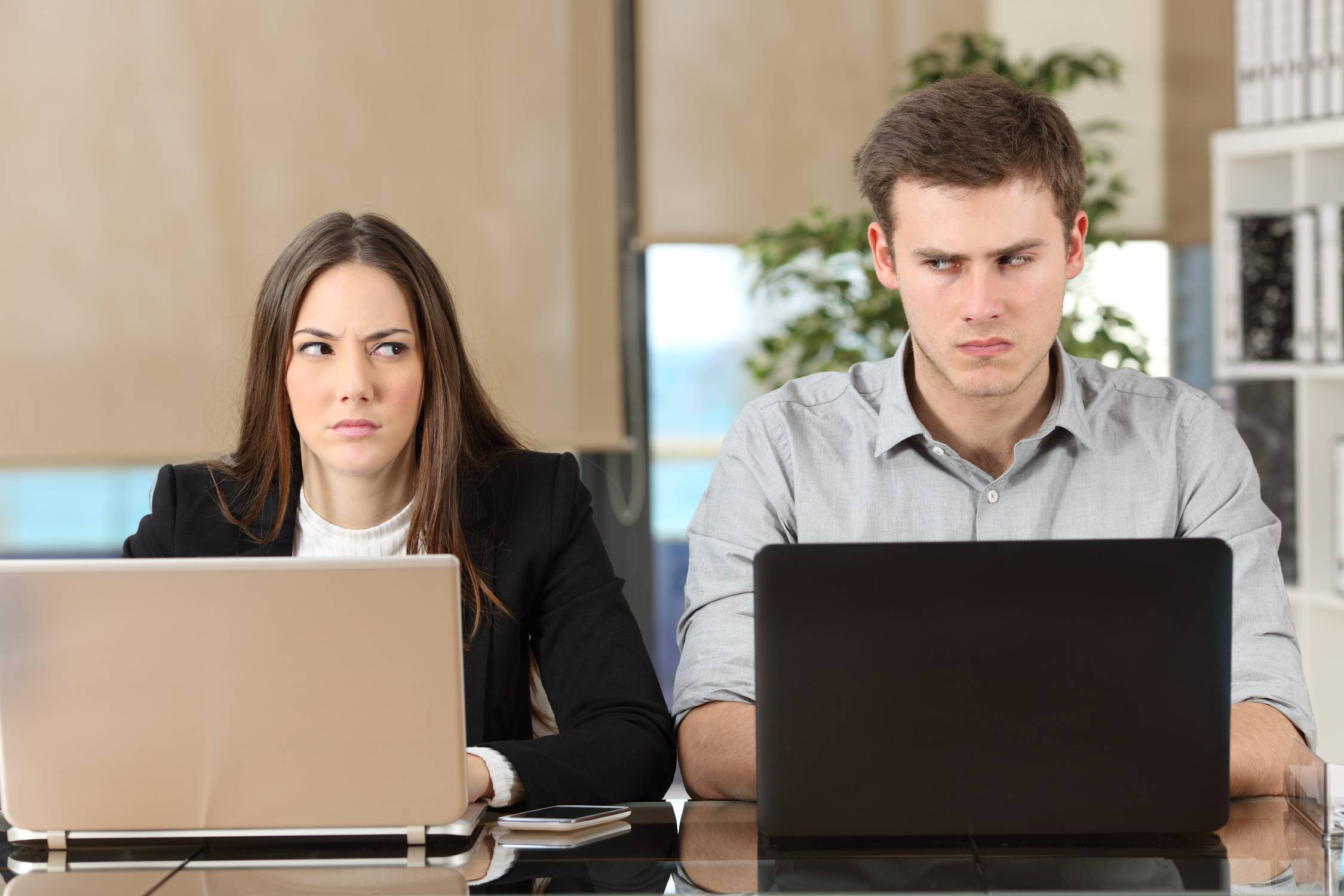 Two angry businesspeople disputing